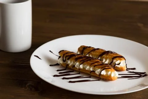 Eclairs with a delicate cream inside Stock Photos