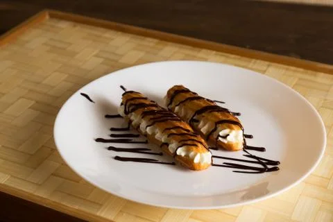 Eclairs with a delicate cream inside Stock Photos
