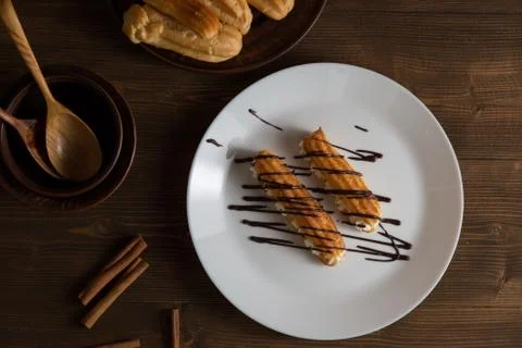 Eclairs with a delicate cream inside Stock Photos