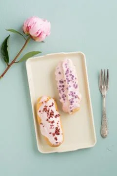 Eclairs with icing Stock Photos