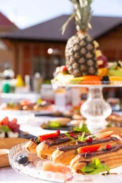 Eclairs in a plate on the table. Stock Photos