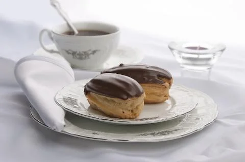 Eclairs with tea Stock Photos