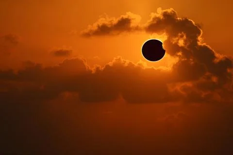 Eclipse on the orange of sunset sky and back little soft cloud Stock Photos
