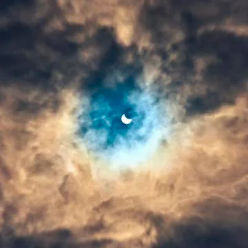 Eclipse of the sun in the afternoon clouds Osred 20.032015 Photos