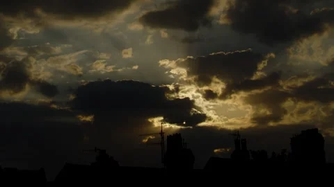 Eclipse Timelapse, Slow pan across rooftops, cloud covered solar eclipse Stock Footage 344028946