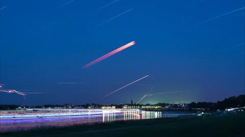 The eclipsed moon is forming a trail over a river landscape Stock Footage 204793406