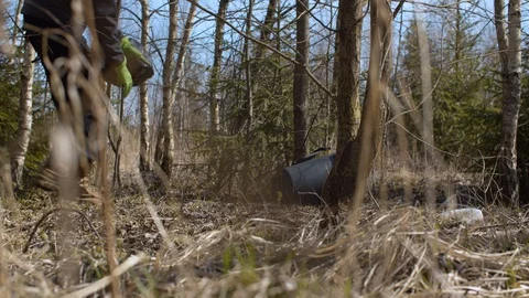 Eco activists picking trash in the forest Stock Footage 128867319