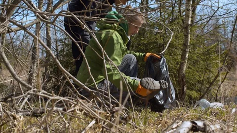 Eco activists picking trash in the forest Stock Footage 128867512