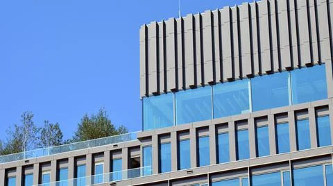 Eco architecture. Green tree and glass office building. Stock Photos