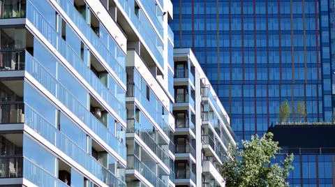Eco architecture. Green tree and apartment building. Stock Photos