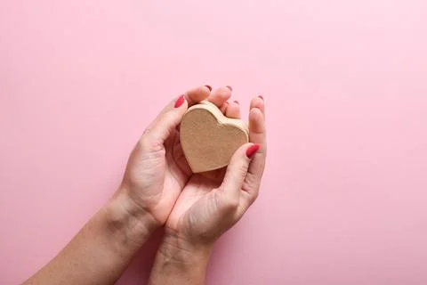 Eco box in the shape of a heart in the hands of a girl. A gift for Valentine' Фото