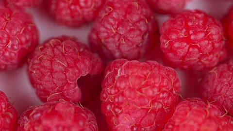 Eco bright colorful berry raspberry rotates on a white background. Pull focus. Stock Footage 157523917