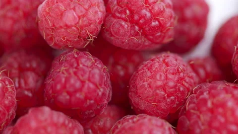 Eco bright colorful berry raspberry rotates on a white background. Macro shot. Stock Footage 157525225