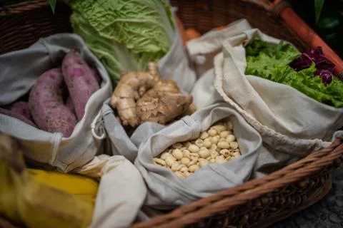 Eco friendly and reusable zero waste cotton bags in basket Stock Photos