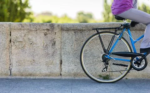Eco friendly background bicycle with unrecognizable person. female rider Stock Photos