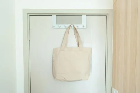 Eco friendly bag hanging on the door. Canvas Shopping tote bag. Zero waste,.. Stock Photos
