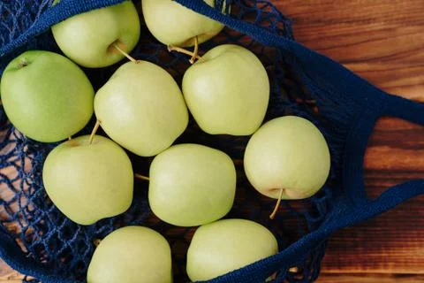 Eco- friendly bag string bag with apple on a wooden background Foto stock