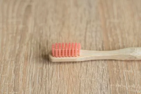 Eco-friendly bamboo toothbrush on a table. Zero-waste. Biodegradable toothbrush. Stock Photos