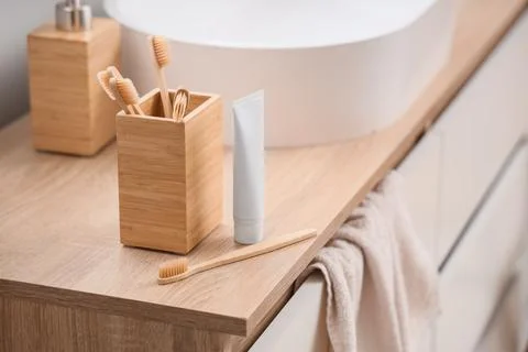Eco-friendly bathroom essentials: bamboo toothbrushes, toothpaste, and soap d Фото