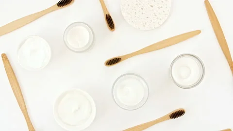 Eco-friendly biodegradable Bamboo toothbrush, White cosmetic bottle containers Vídeo Stock 237017603