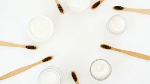 Eco-friendly biodegradable Bamboo toothbrush, White cosmetic bottle containers Stock Footage 244781737