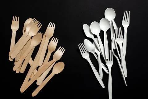 Eco-friendly disposable tableware on a black background. Stock Photos