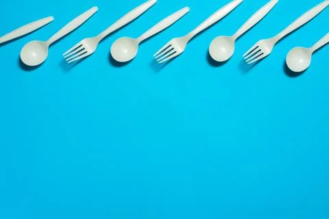Eco-friendly disposable tableware on a blue background. Stock Photos