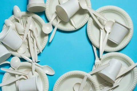 Eco-friendly disposable tableware on a blue background. Stock Photos