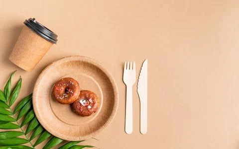 Eco friendly disposable tableware on brown background Stock Photos