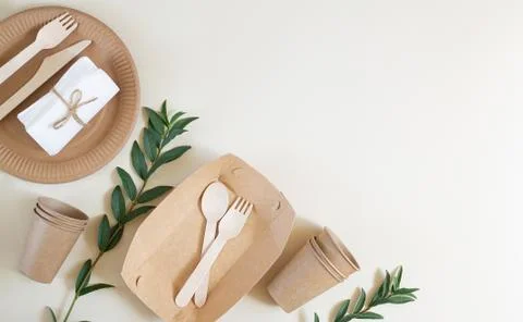 Eco-friendly disposable tableware for fast food on the beige background. Plas Stock Photos