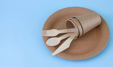 Eco friendly disposable tableware on light blue background with copy space Stock Photos