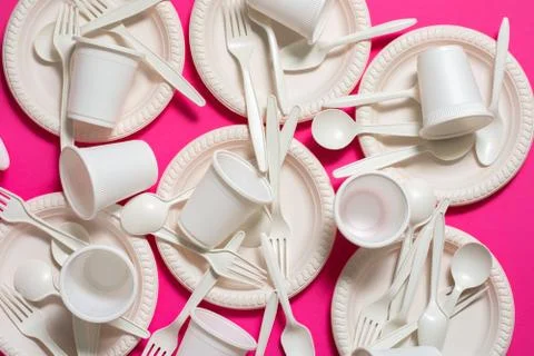 Eco-friendly disposable tableware on a pink background. Stock Photos