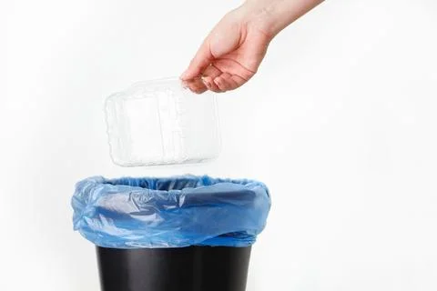 Eco-friendly disposal of plastic container by a woman on white background Foto stock