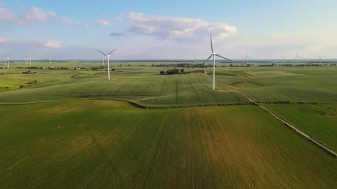 Eco-friendly energy from wind generator. Windmill blades in motion against rural Stock Footage 303483273