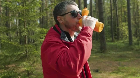 Eco friendly man drinking coffee from reusable mug in forest Stock Footage 318160533