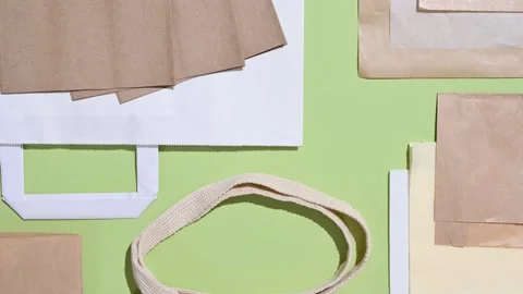 Eco-friendly packaging and shopping bags on a green background. Stock Footage 224333637
