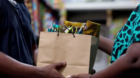 Eco-friendly paper bag containing African print Ankara fabric textiles 動画素材 346094890