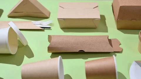 Eco-friendly paper tableware for fast food on a green background. Stock Footage 227212327