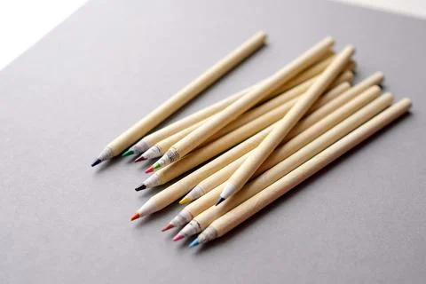 Eco-friendly pencils on a gray background. Colored recyclable crayons Stock Photos