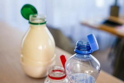 Eco-friendly plastic bottles with attached caps for recycling and sustainability Stock Photos