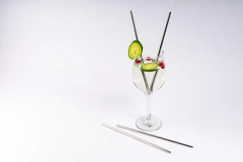 Eco-Friendly Refreshment: Clear Drink in a Glass with Reusable Metal Straws.. Stock Photos