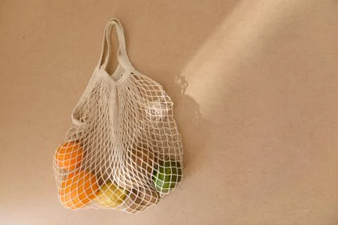 Eco friendly reusable mesh string knitted shopping bag with fruits and Stock Photos