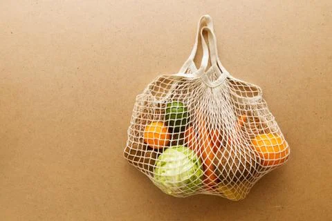 Eco friendly reusable mesh string knitted shopping bag with fruits and Stock Photos