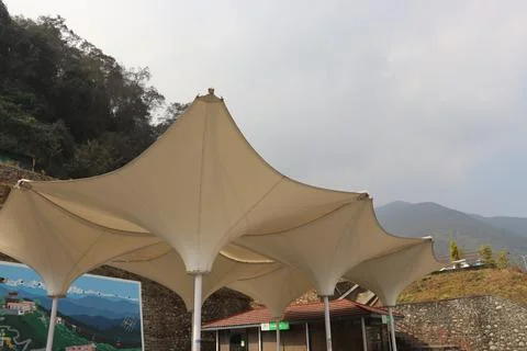 Eco friendly roof structure of sails created for shadow in mountain region Stock Photos