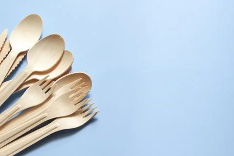 Eco-friendly tableware. Spoons, forks, knives made of wood. Stock Photos