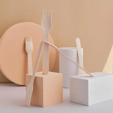 Eco-friendly tableware, wooden forks placed on trendy geometric pedestals Stock Photos