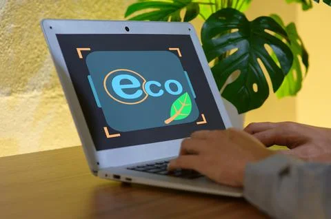 Eco-Friendly Technology Concept with Laptop and Green Leaf Symbol Stock Photos