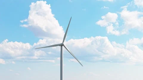 Eco-Friendly Wind Turbine Rotating Near Shipka with Fluffy Clouds in Background Stock Footage 313351455