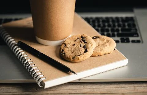 Eco-Friendly Work Concept, Disposable Cup, cookies and Recycled notebook. Stock Photos