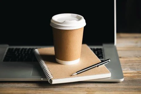 Eco-Friendly Work Concept, Disposable Cup and Recycled Notepad on Laptop. Stock Photos